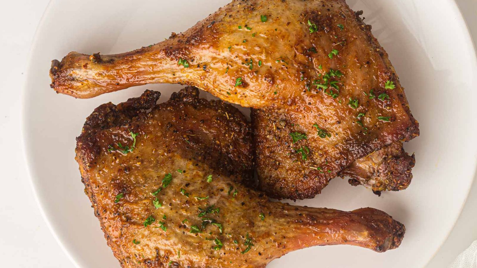 Air-fried duck legs with crispy golden skin and juicy meat inside.