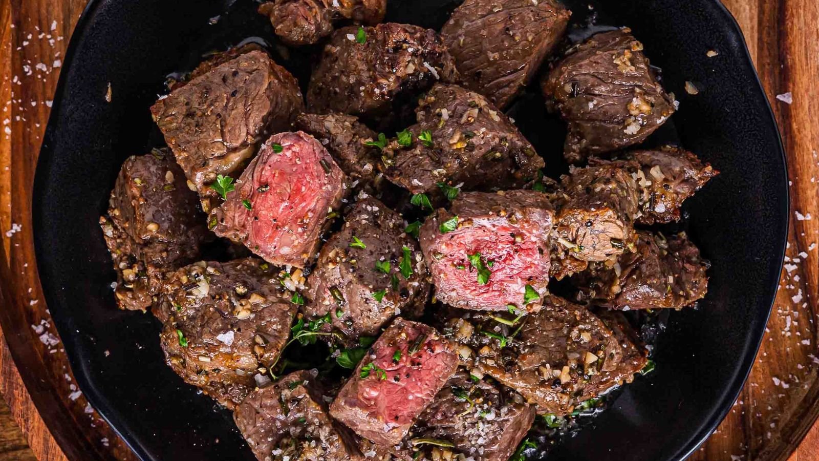 Air fryer garlic butter steak bites seared with browned edges.