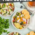 Three bowls of fish ceviche with avocado, tomatoes, onions, and crackers are arranged on a light green surface with fresh cilantro and drinks nearby.