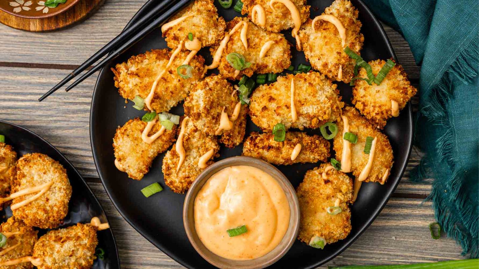 Air fryer bang bang chicken bites coated in sweet, spicy sauce.