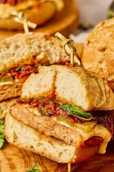 Gochujang Chicken Burgers cut in half and served on a wooden board.