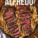 A skillet filled with fettuccine Alfredo topped with sliced, medium-rare steak and garnished with herbs, accompanied by text about making steak Alfredo.