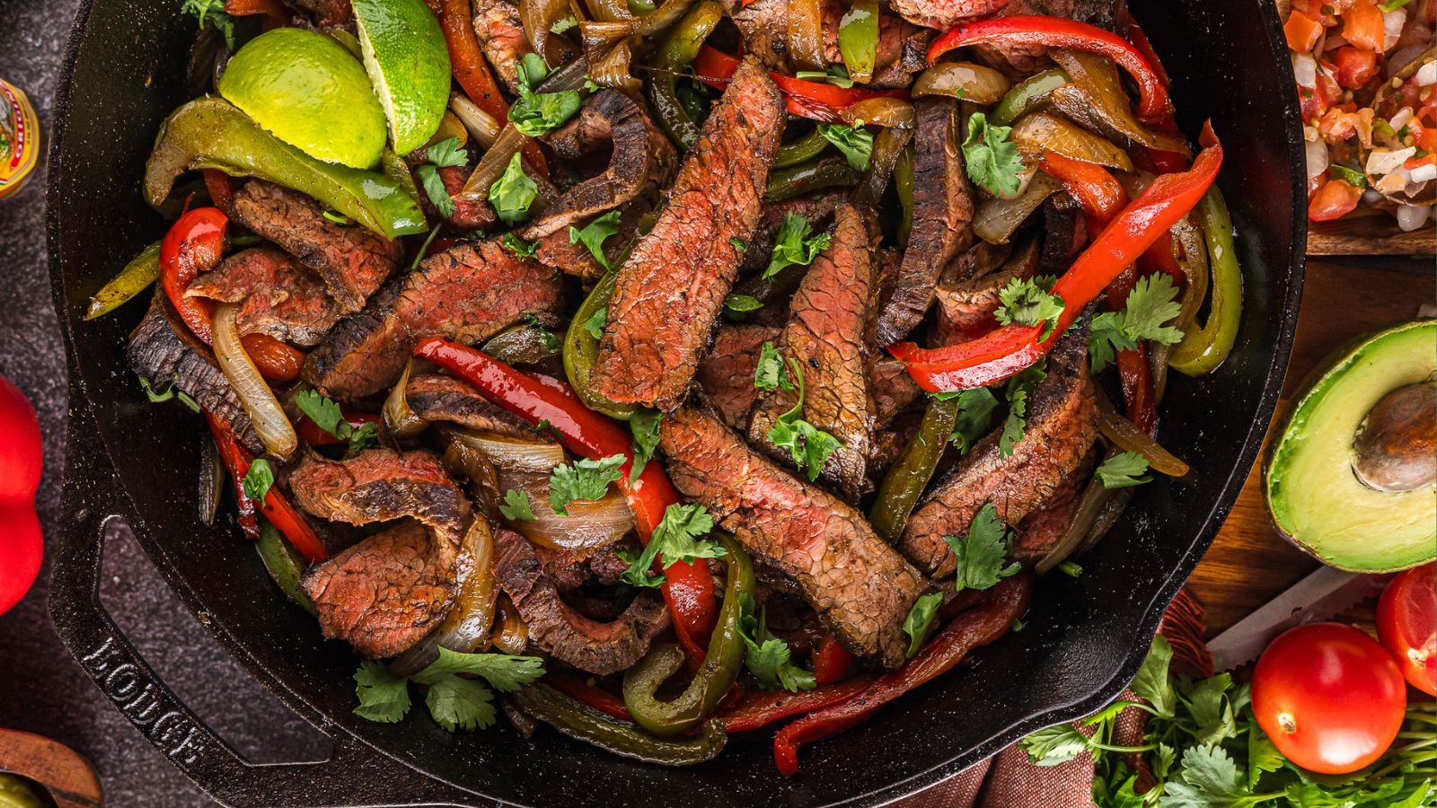 Steak fajitas with sizzling sliced steak, peppers, and onions.