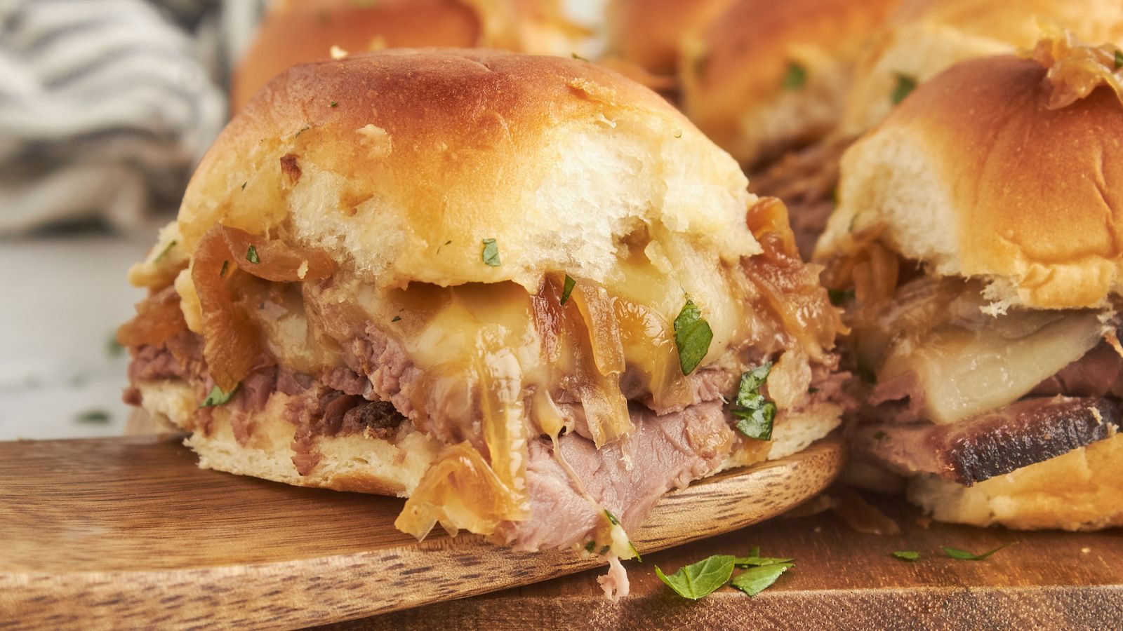 French dip sliders with tender beef and warm jus for dipping.