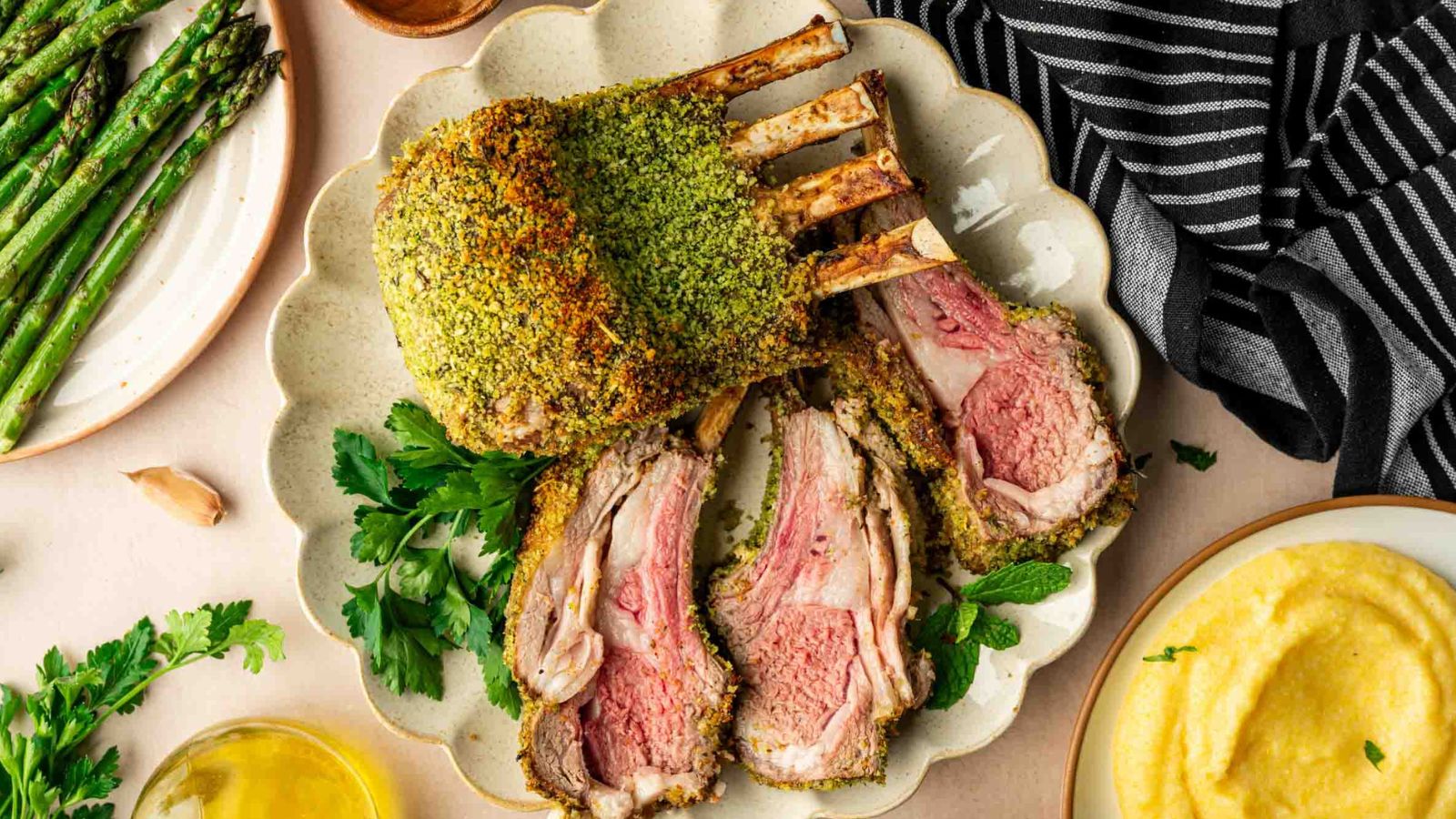 Rack of lamb coated in Dijon and fresh herbs with a browned crust and juicy center.