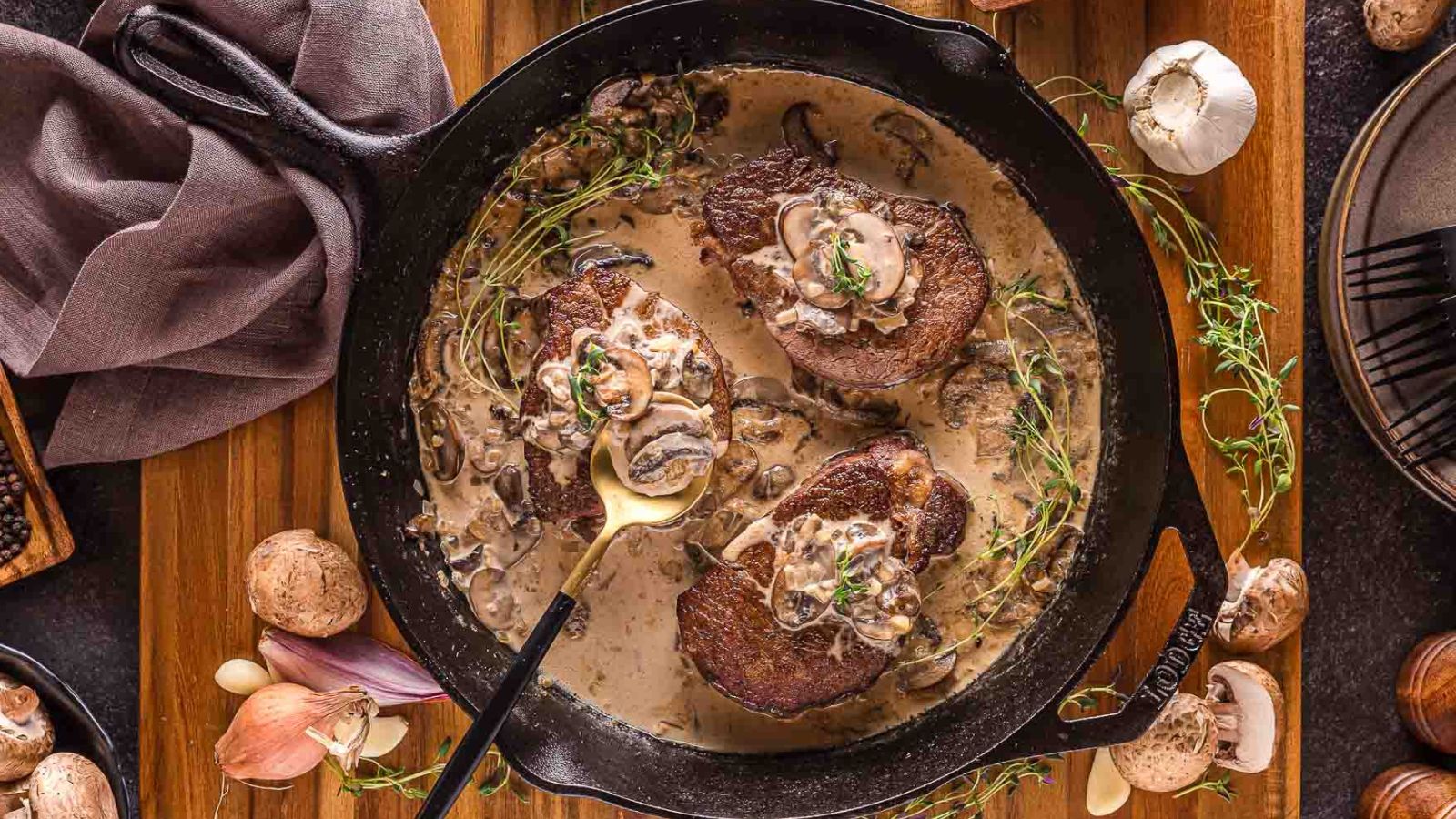 Steak topped with creamy mushroom sauce over a browned, pan-seared crust.