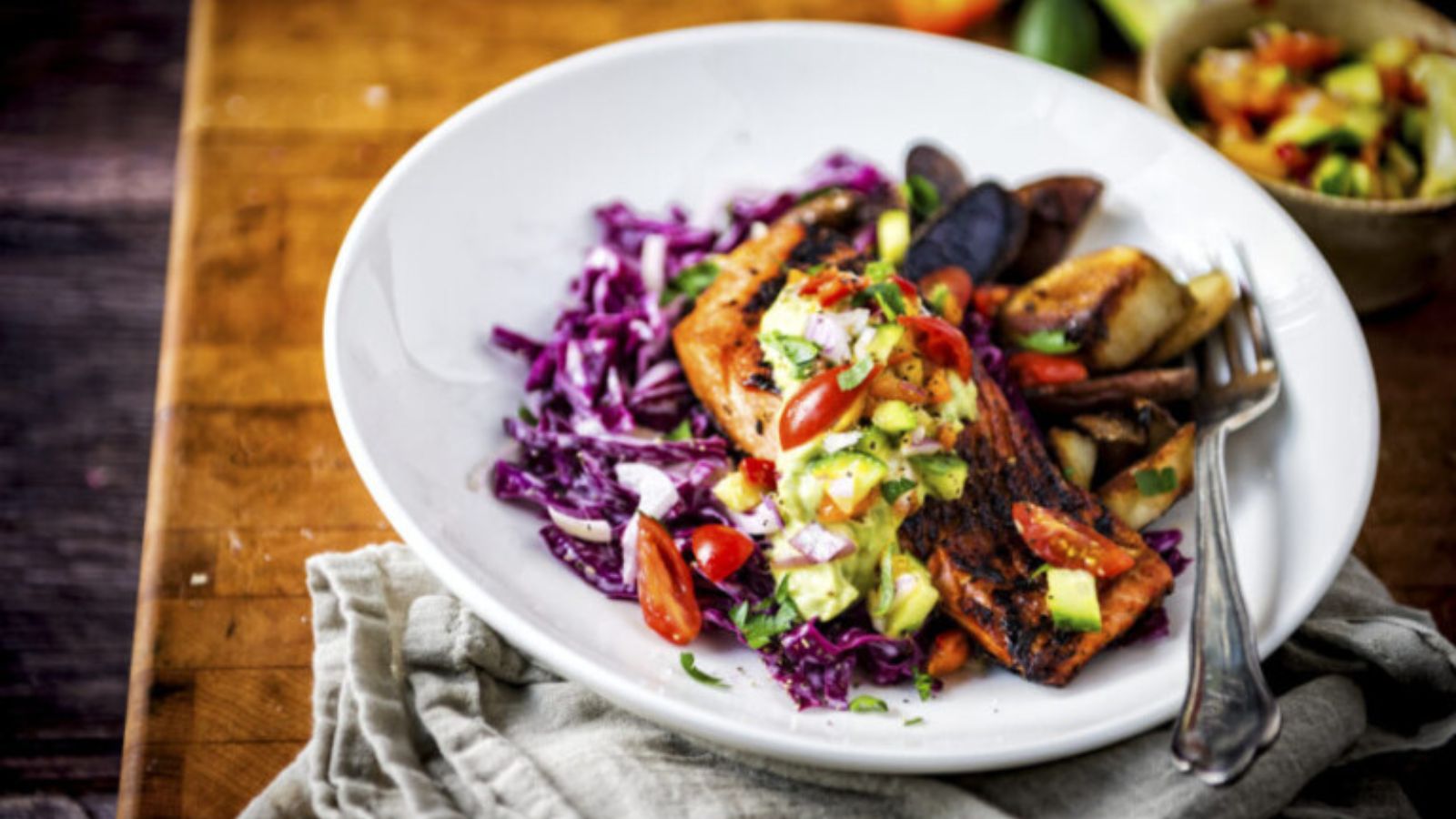 Salmon blackened in cast iron with dark charred crust and flaky interior.