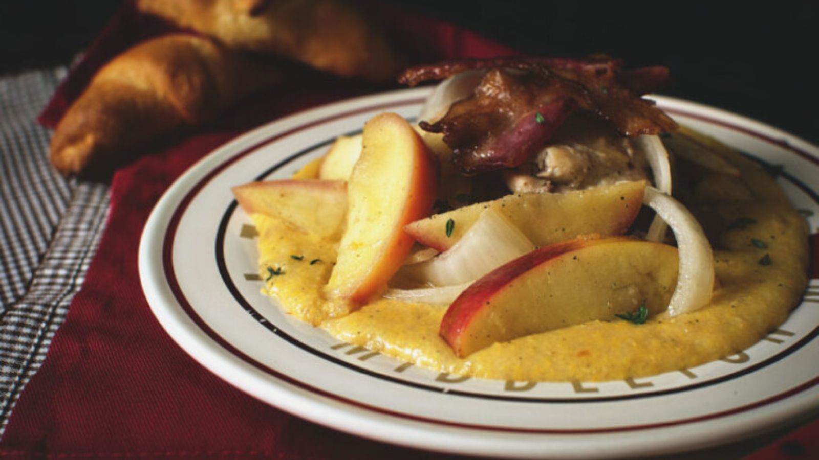 Chicken thighs cooked with apples and onions in a savory skillet mix.