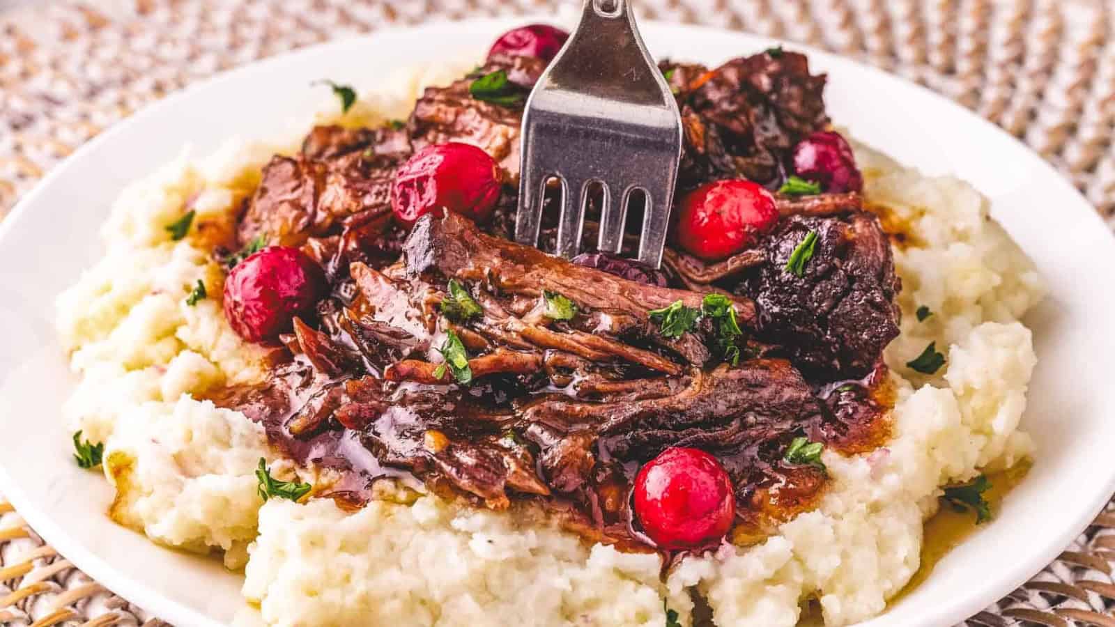 Crockpot cranberry pot roast cooked in a sweet tangy sauce.