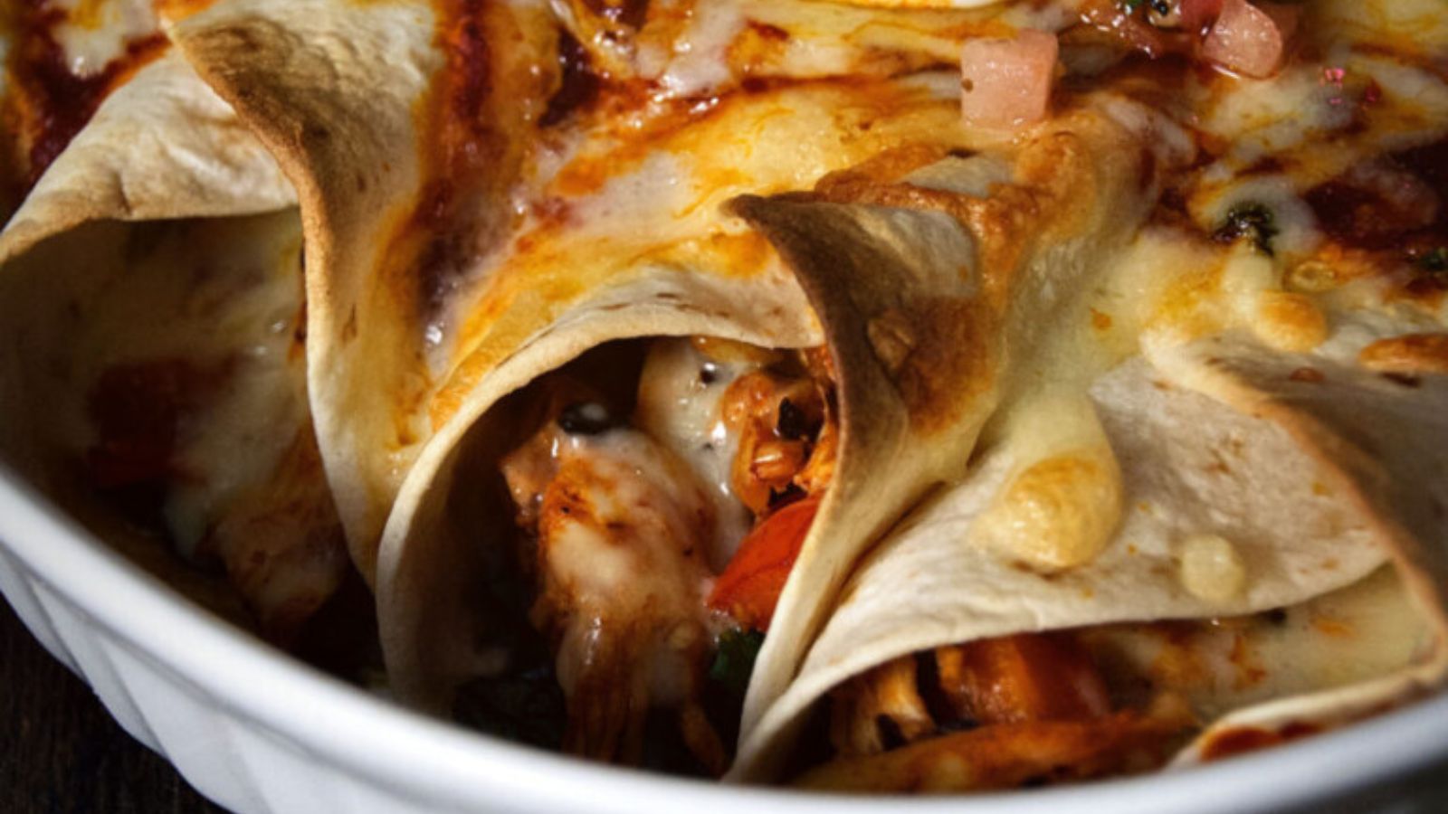 Weeknight enchiladas filled with chicken and topped with melted cheese.