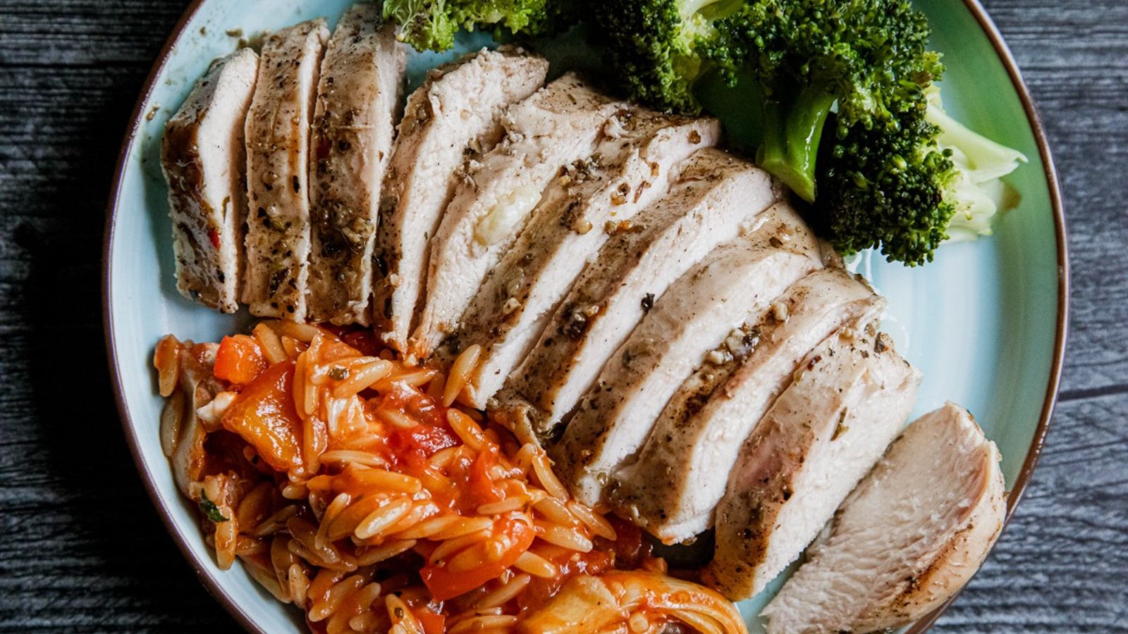 Grilled Greek chicken with charred edges and a bright herb marinade.