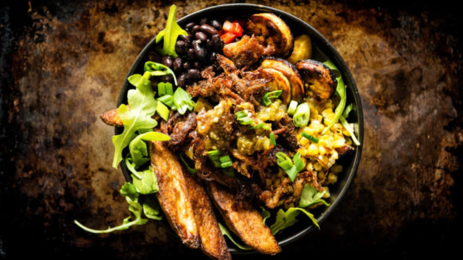 Leftover carnitas potato bowl loaded with carnitas, potatoes, and toppings.