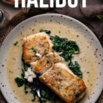 Plate with two pieces of pan-seared halibut on a bed of cooked spinach, topped with sauce. A fork rests on the plate and text above reads, "How to make pan seared halibut.