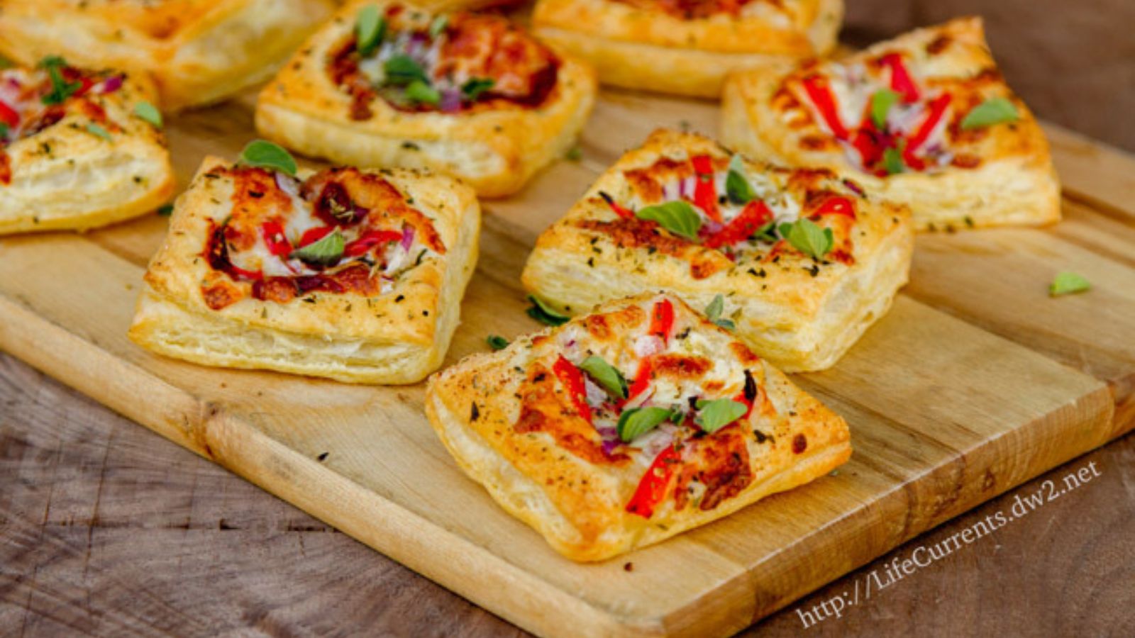 Pizza tarts topped with cheese and sauce baked in crisp pastry.