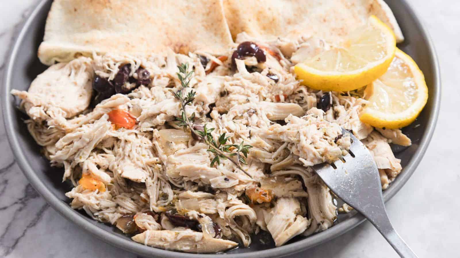 Slow cooker Greek chicken cooked tender with herbs and lemon.