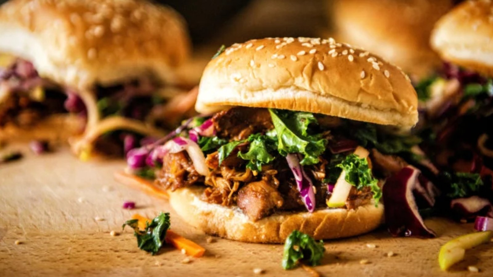 Sliders filled with hoisin pulled pork topped with spicy kale slaw.