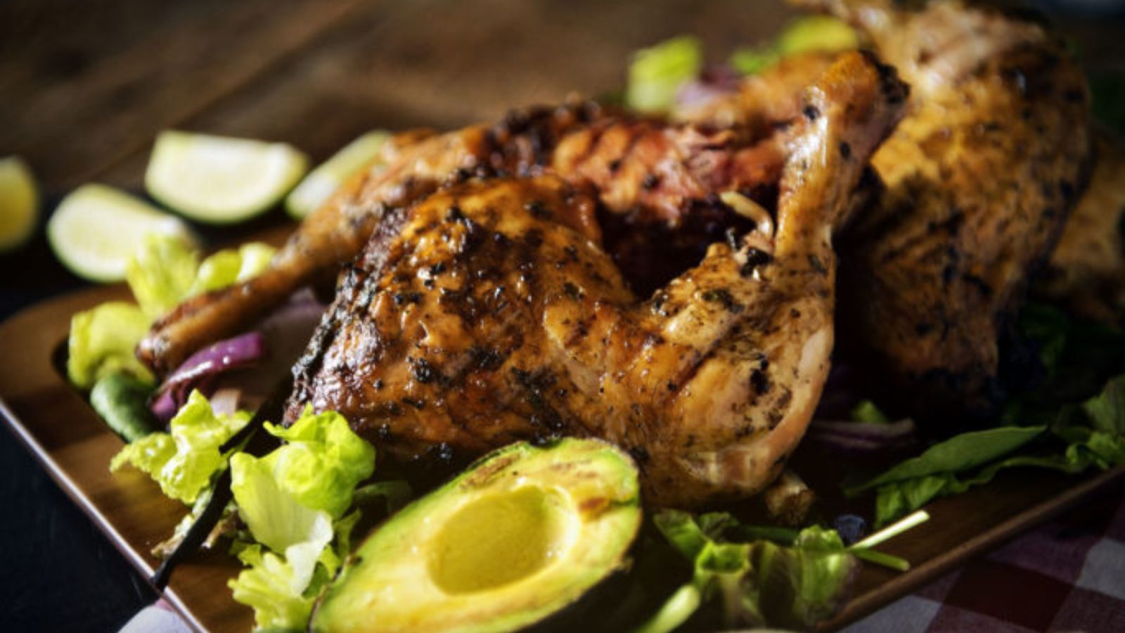 Leg quarters smoked and plated with grilled avocado and scallions.