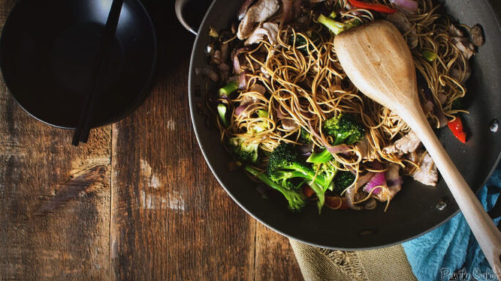 Pork lo mein stir fried quickly with vegetables and noodles.