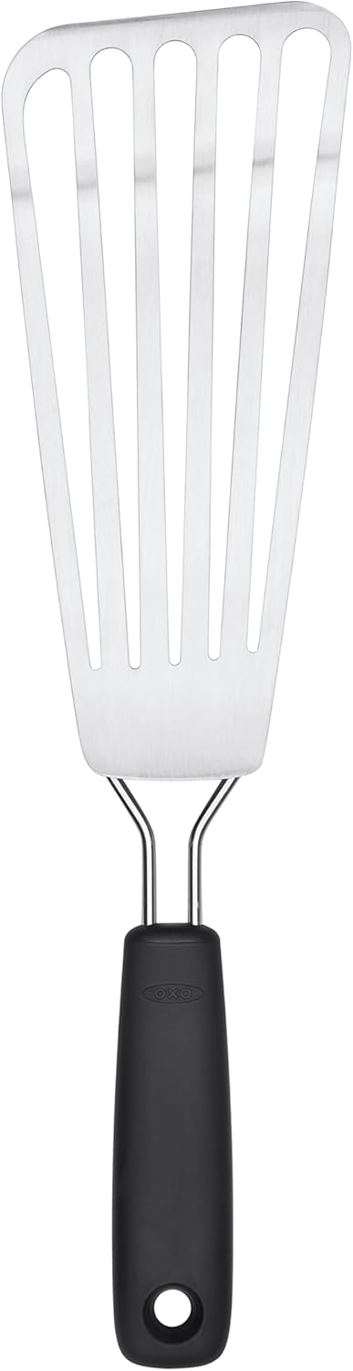 A metal slotted spatula with a black handle, designed for flipping and serving food.