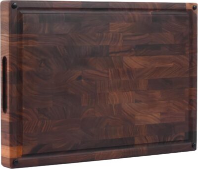 Rectangular wooden cutting board with dark wood grain, a juice groove around the edge, and a handle slot on the sideโideal for those learning how to carve a prime rib with ease and style.