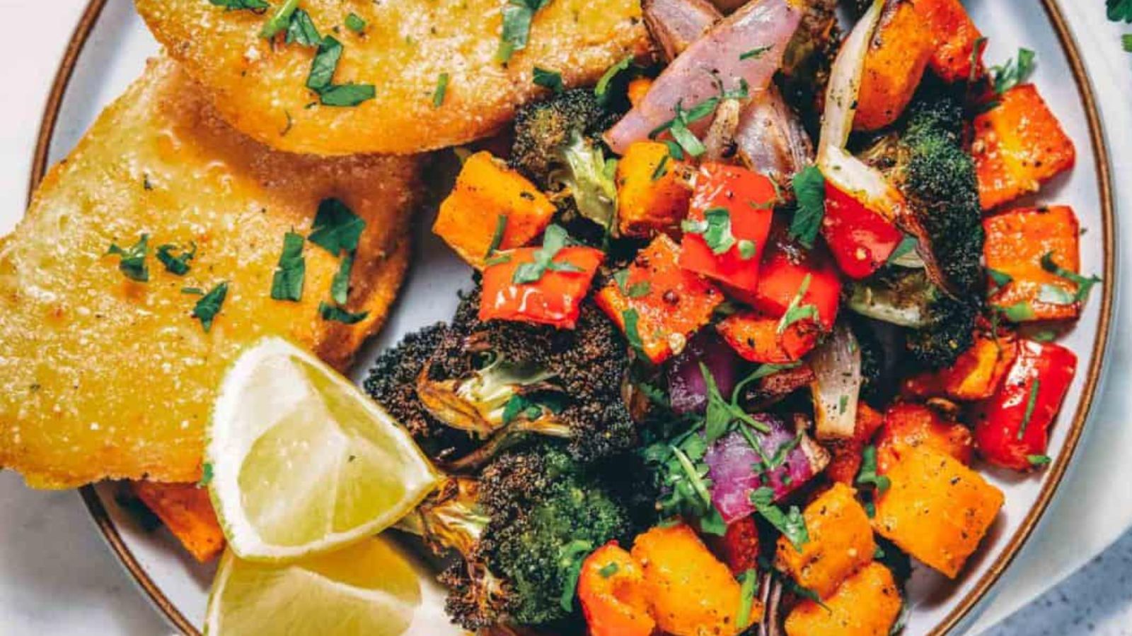 Air fryer vegetables charred lightly with bright colors and crisp edges on the tray.