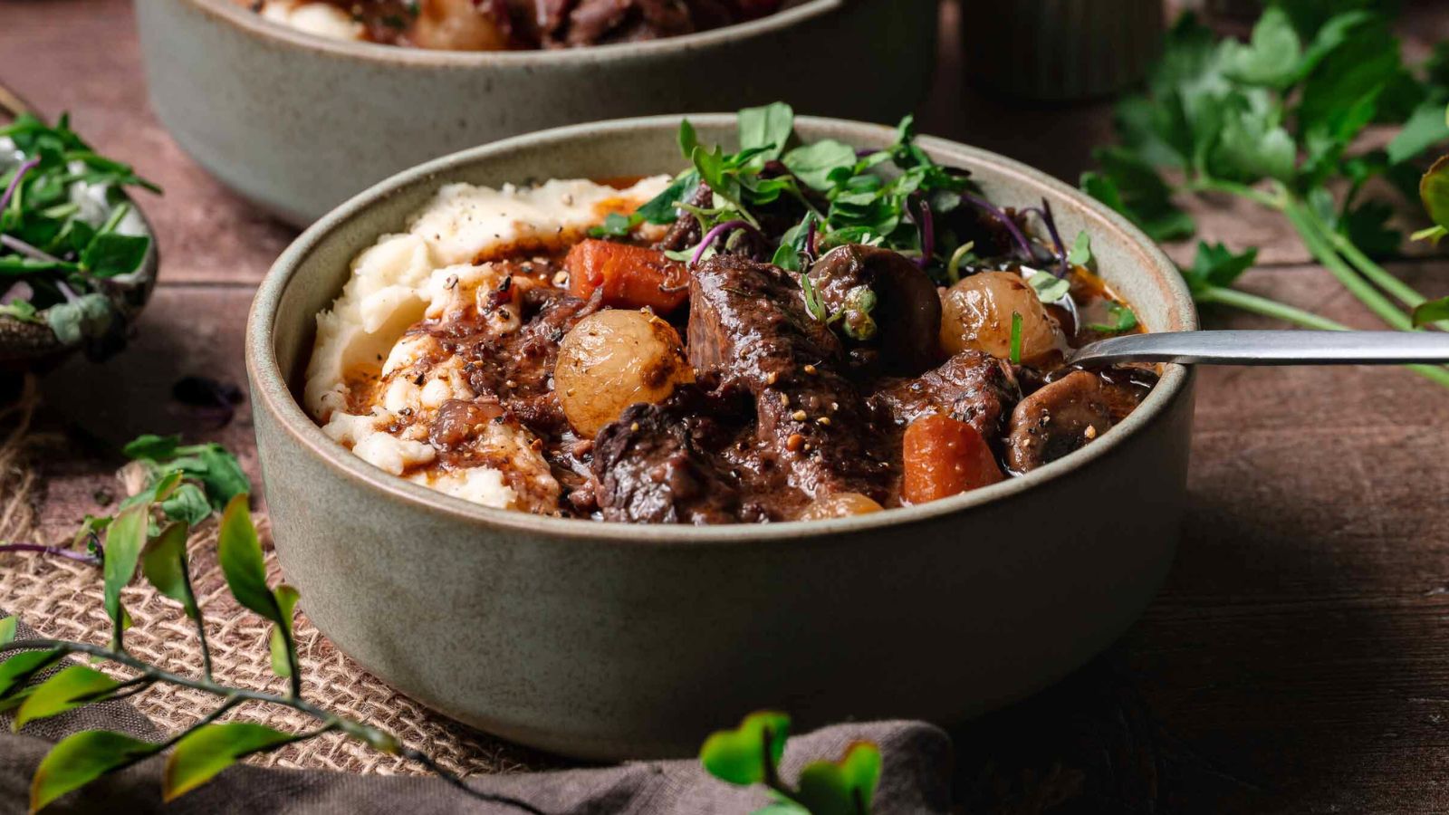 Slow-cooked beef bourguignon with vegetables and sauce.
