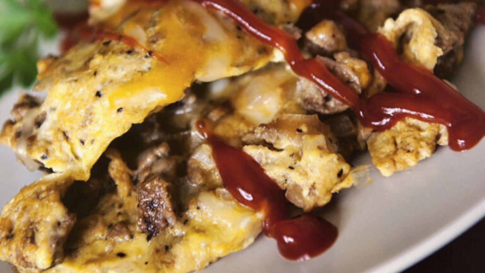 Omelette folded around ground beef and melted cheese like a cheeseburger in egg form.
