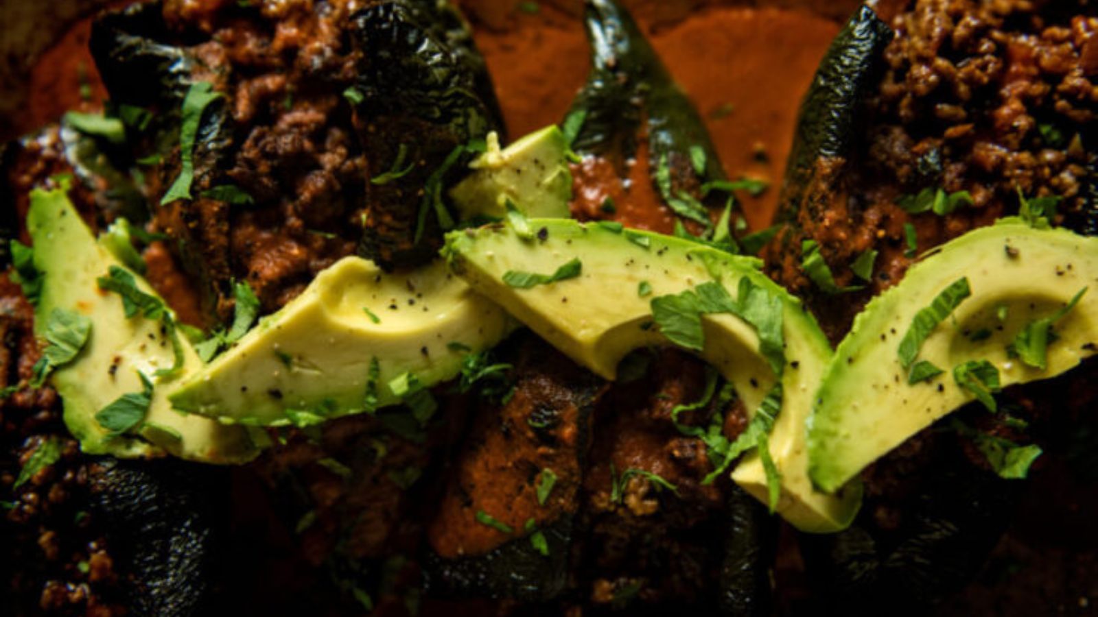 Stuffed poblano peppers smoked with enchilada filling until bubbling.