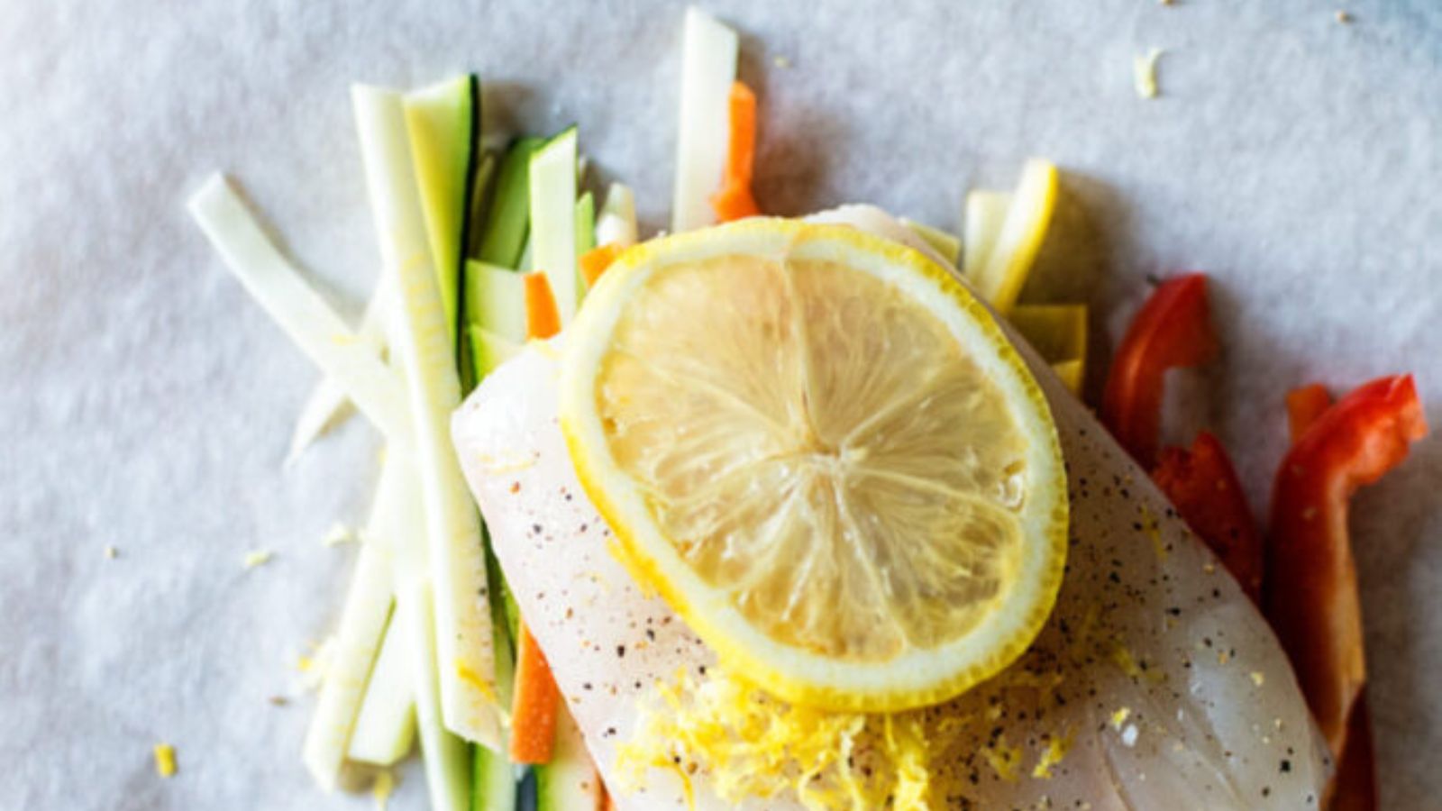 Halibut baked in parchment with pistachio mint pesto coating.