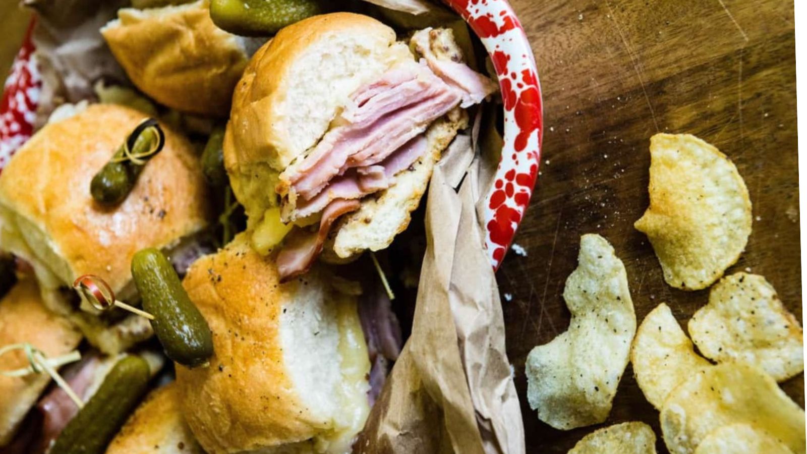 Sliders layered with ham and cheese baked until gooey.