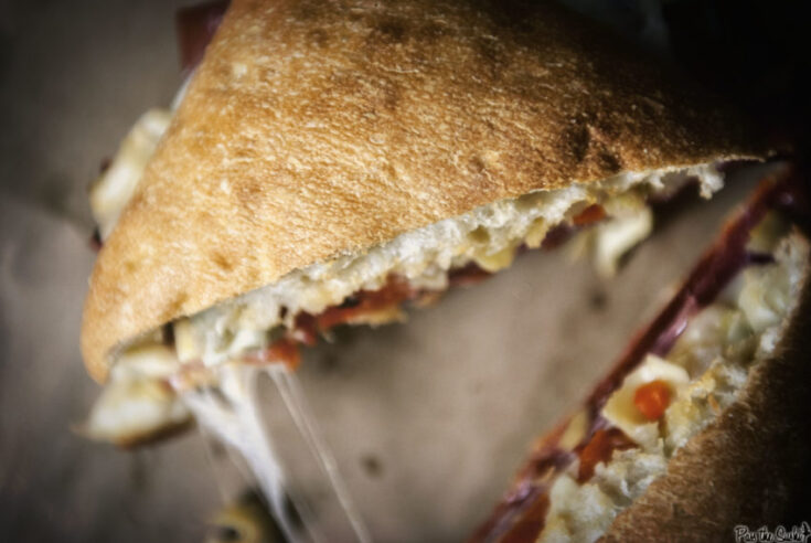 Ciabatta sandwich layered with Italian meats and cheese.