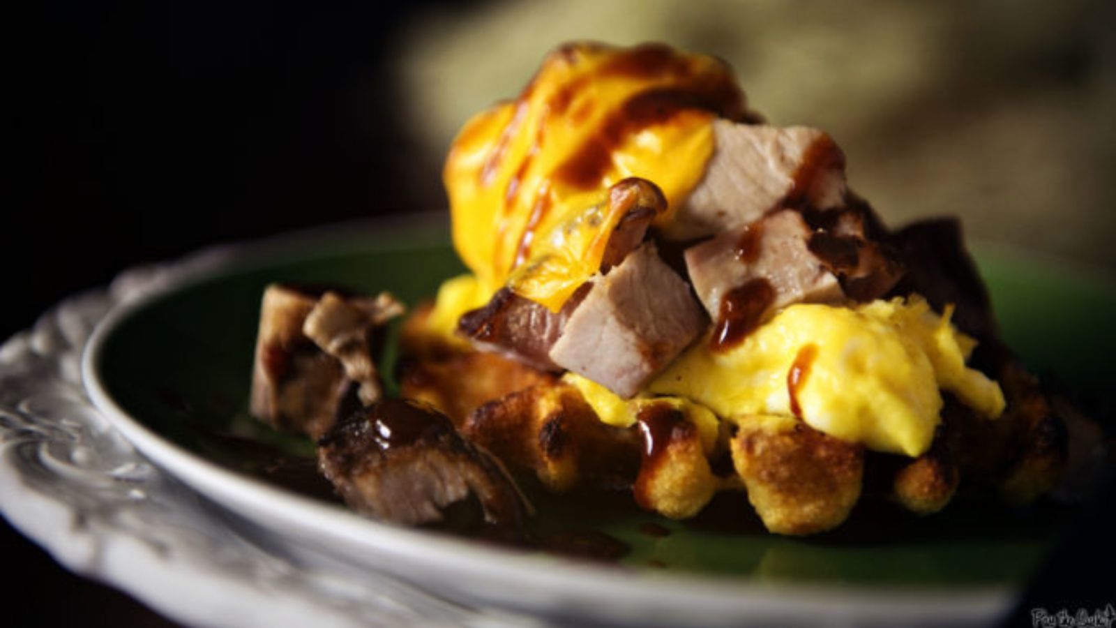 Ham and egg sandwich served open-face on toasted waffle.