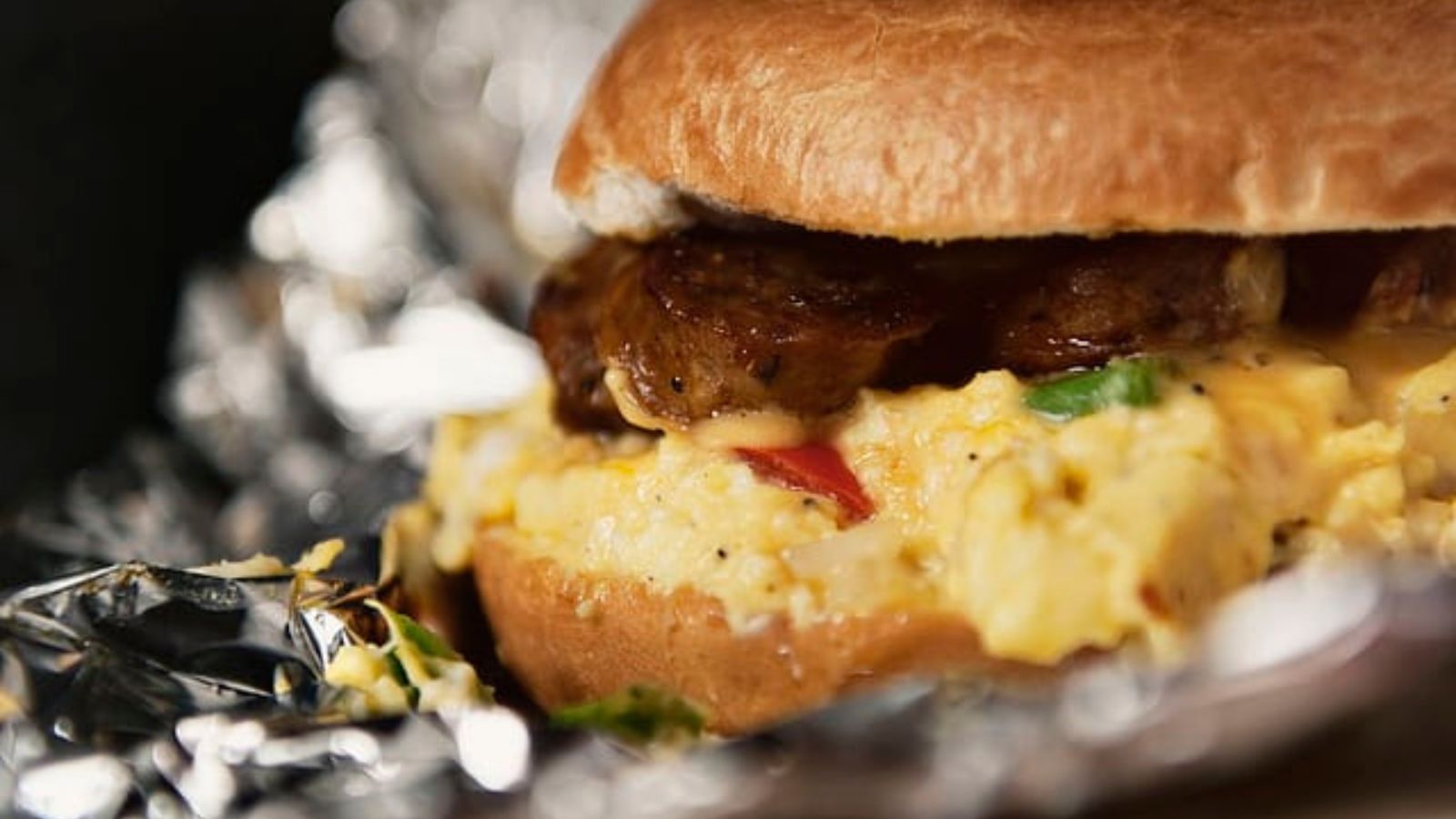 Sausage egg and cheese bagel sandwich stacked warm.