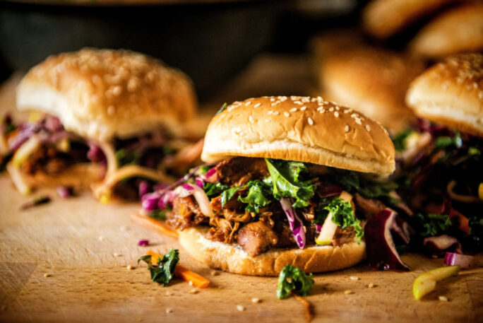 Sliders filled with hoisin pulled pork topped with spicy kale slaw.