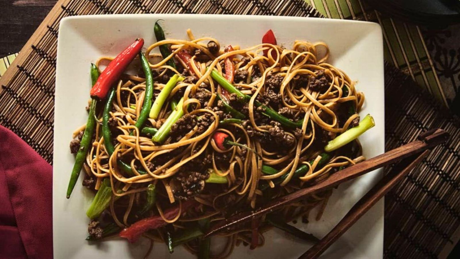 Szechuan beef noodles cooked spicy with chili oil and herbs.