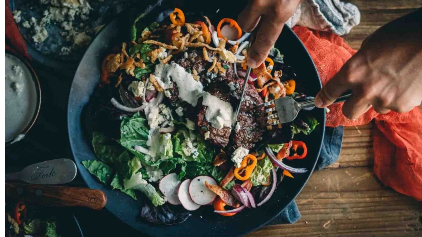 Hamburger salad topped with seared beef and keto blue cheese dressing.