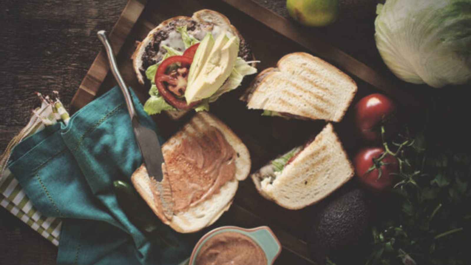 Hamburguesas served on torta rolls with toppings.