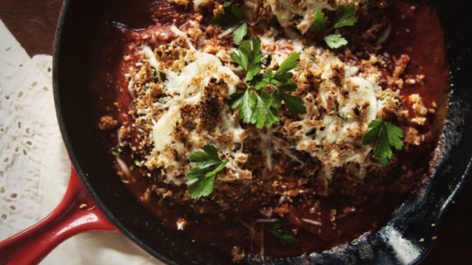 Chicken Parmesan cooked in skillet for fast meal.