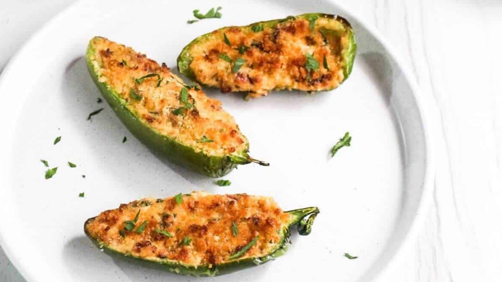 A plate of jalapeño poppers on a table.