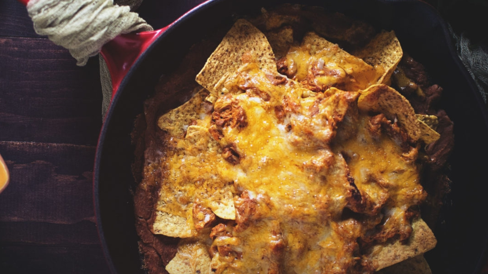 Nachos topped with chicken enchilada filling baked until bubbly.