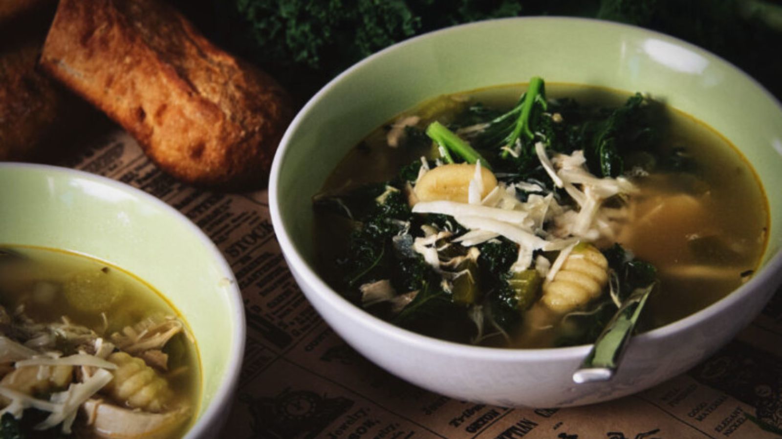 Soup with chicken, gnocchi, and kale in creamy broth.