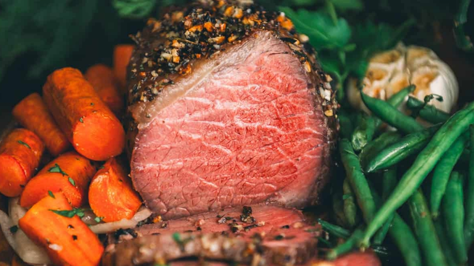 Beef bottom round roast sliced thin showing tender pink interior and browned exterior.