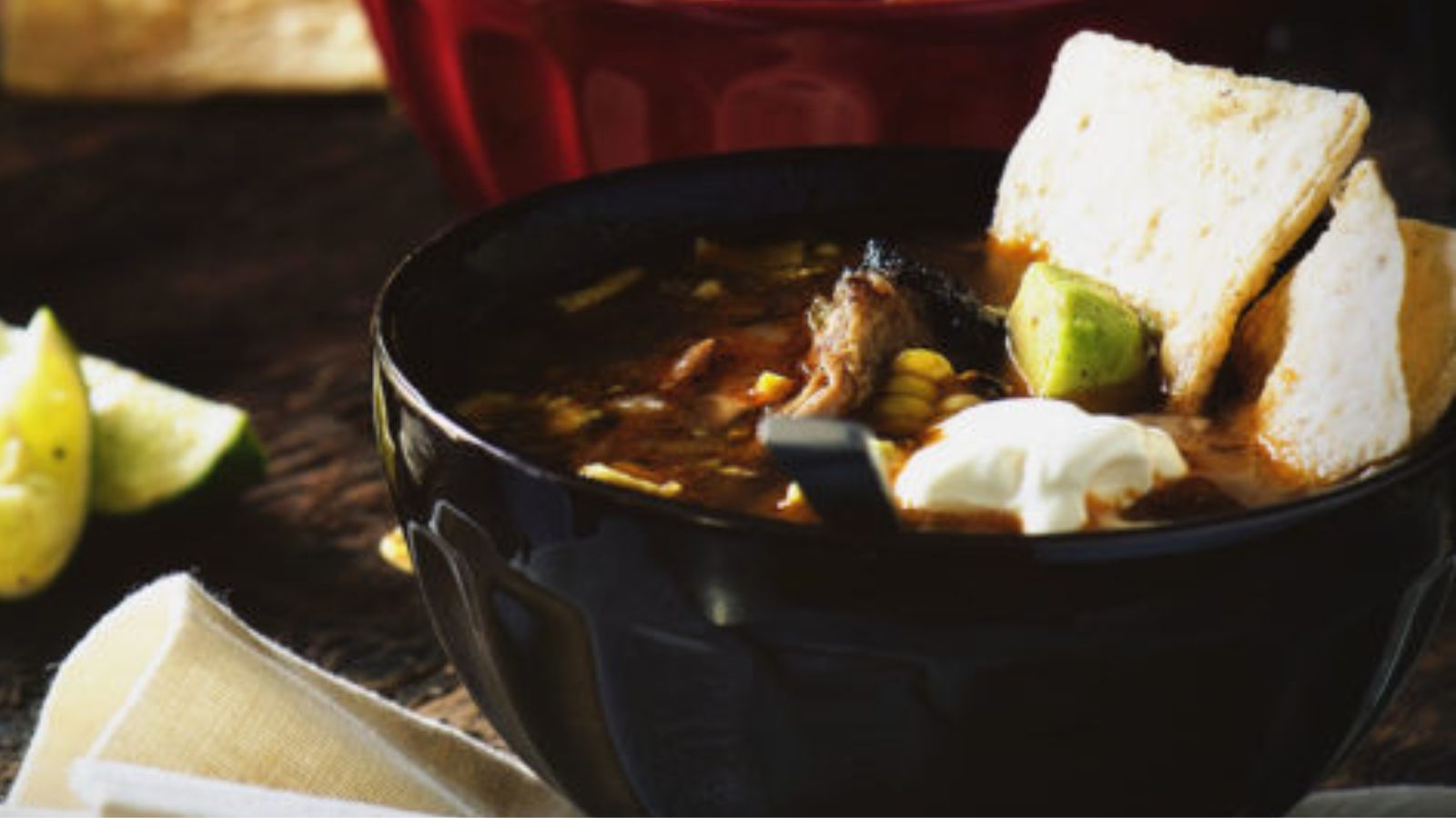 Tequila tortilla soup featuring grilled chicken pieces and hearty broth.