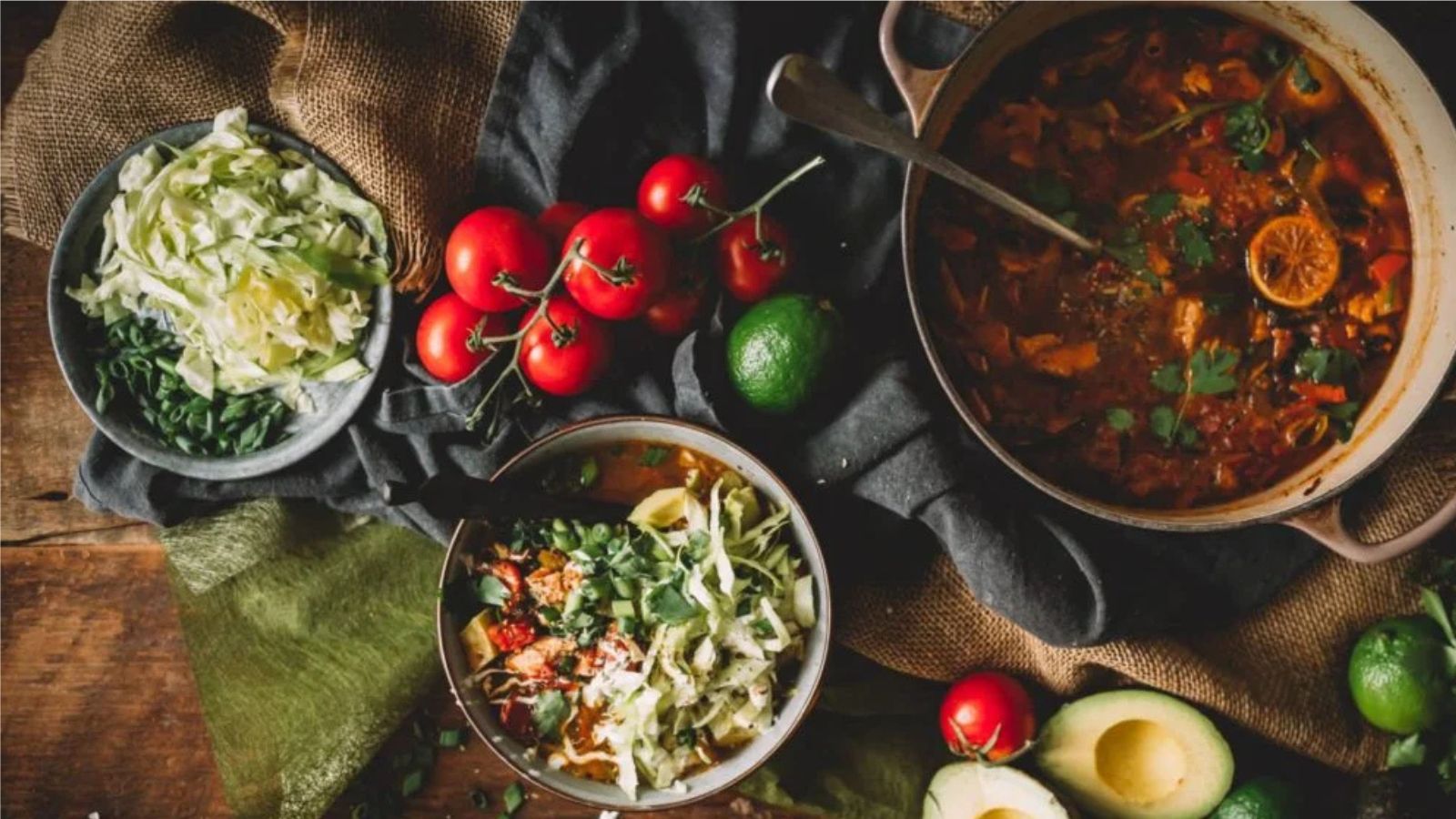 Mexican chicken soup with vegetables and herbs simmering in broth.