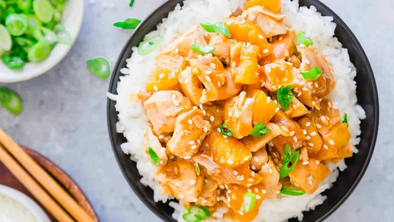 Honey garlic chicken in a bowl served over rice.