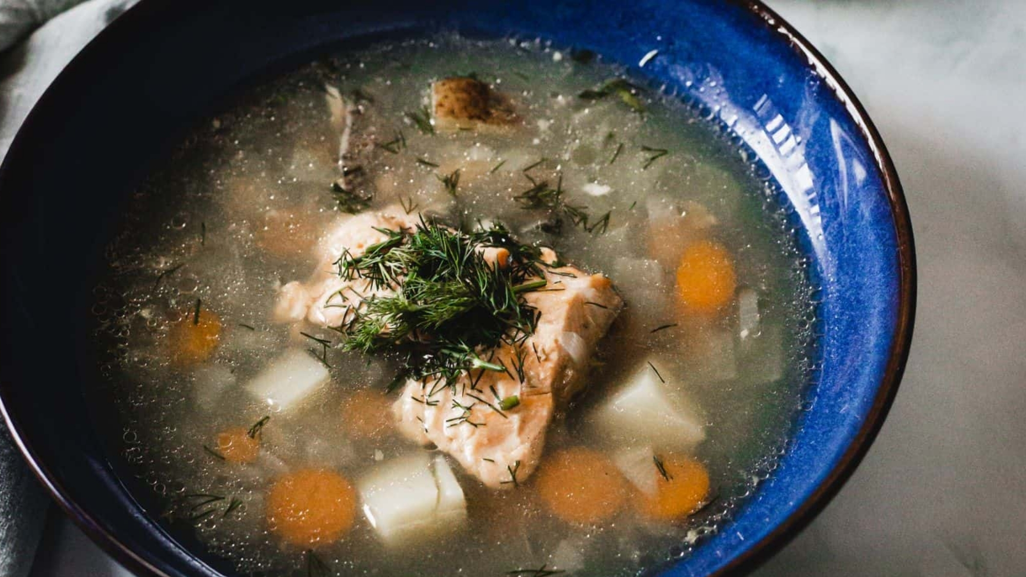 Overhead view of blue bowl of soup.