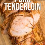 Sliced air fryer pork tenderloin on a wooden cutting board, with text overlay promoting a recipe from girlcarnivore.com.