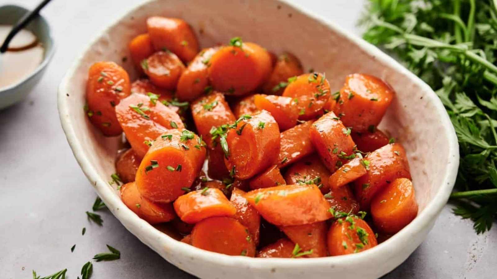 Air fryer glazed carrots in a bowl with parsley.