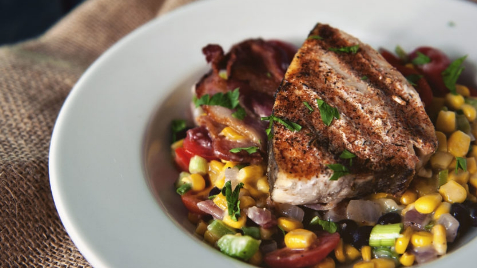 Swordfish blackened served with creamy maque choux.