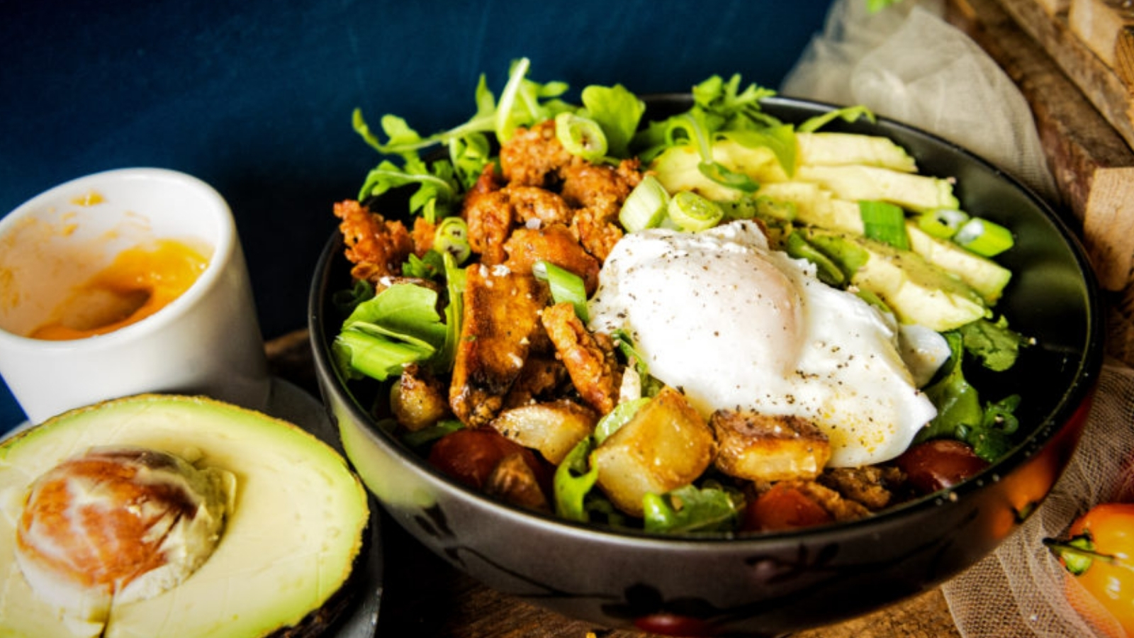Breakfast bowl with chorizo, potatoes, and chipotle cream creating smoky heat.